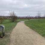 Wintry photo of a grassy area with long path running through it