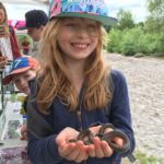 Photograph of a girl holding a snake