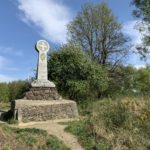 Photo of a stone memorial with a carved cross and inscription in memory of Queen Victoria