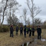 Photo of a group of wardens talking to the team from Marwell Wildlife.