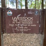 Photo of a sign that warns "LIVESTOCK are currently in this paddock. Dogs must be kept on leads".