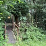 Photo of a small bridge leading to a gate marked "Pet Cemetery".