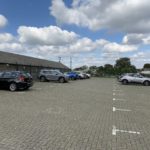 Photo of the car park at Nailshes Wood. It's a large, level car park with spaces marked out with white lines. It's made of block paving.